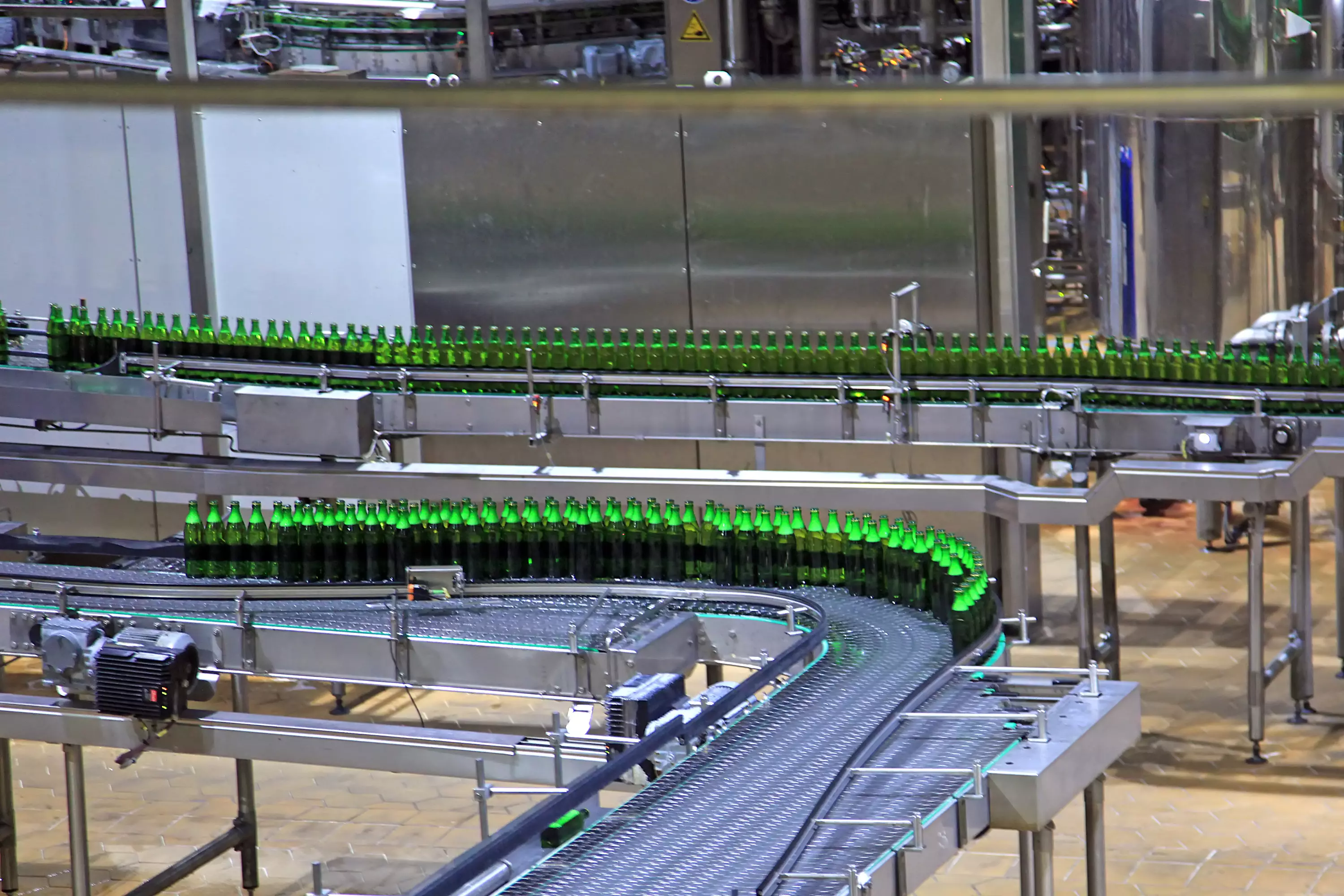 A production conveyor belt with bottles for the food and beverage industry